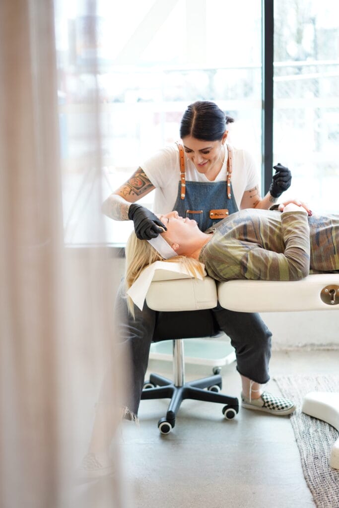 Woman receiving permanent makeup service